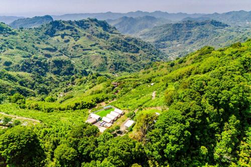 an aerial view of a mountain valley with houses at Top of Mountain Miaoli in Taian