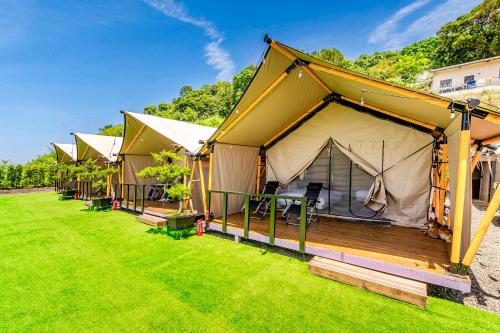 a row of tents on a grass field at Top of Mountain Miaoli in Taian