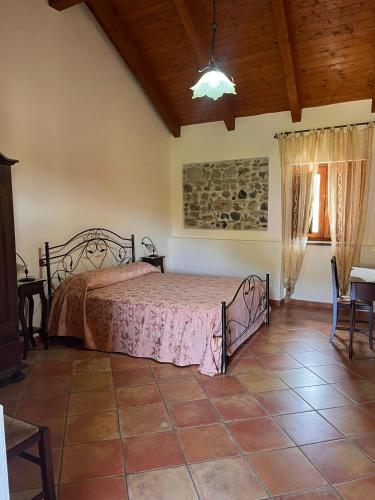 a bedroom with a bed and a wooden ceiling at Country House B&B Antica Dimora Del Sole in Camerota