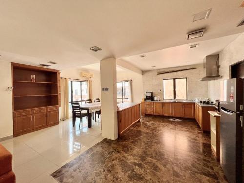 a kitchen with a table and a dining room at 4 Bedrooms PENTHOUSE MARINA COURT VACATION HOME KOTA KINABALU 14pax in Kota Kinabalu