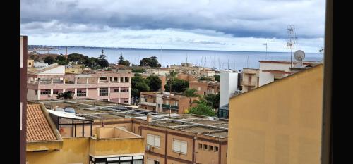 a view of a city with buildings and the ocean at B&B da Giovy in Marsala