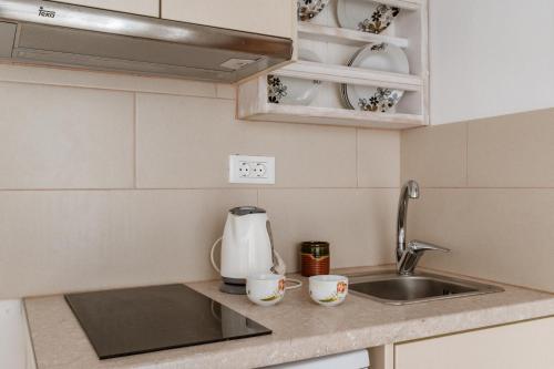 a kitchen counter top with a sink and a sink at Cyclades Beach 3 in Sifnos