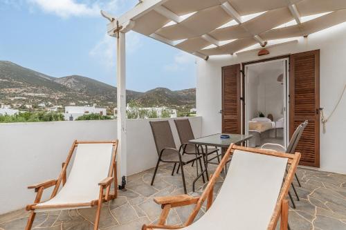 a patio with a table and chairs on a balcony at Cyclades Beach 3 in Sifnos