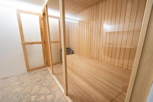 a wooden sauna with a glass door in a room at Hotel Maslina in Seget