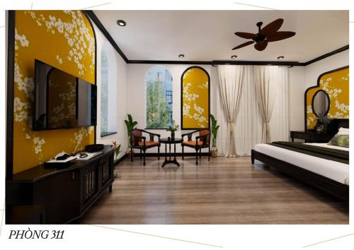 a bedroom with a bed and a table with chairs at Q Villa Hotel in Xuan An