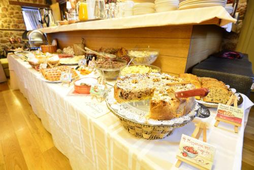 a table with bread and other foods on it at Mavraganeiko in Synikia Mesi Trikalon