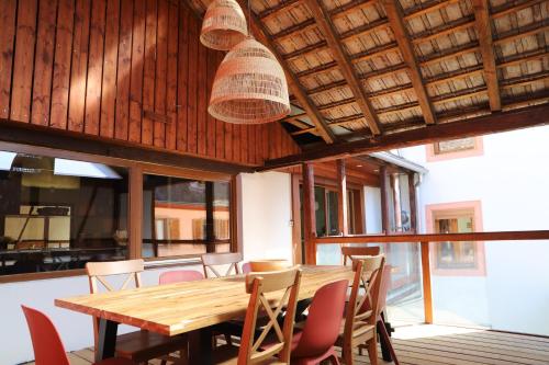 une salle à manger avec une table et des chaises en bois dans l'établissement Chez Emilie, à Gueberschwihr
