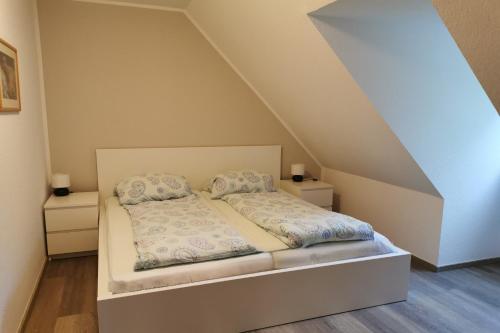 a bedroom with a bed with two pillows at Beekenhof in Bommelsen