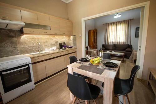 a kitchen with a table and chairs in a room at Matina's Village Getaway in Antipernoí