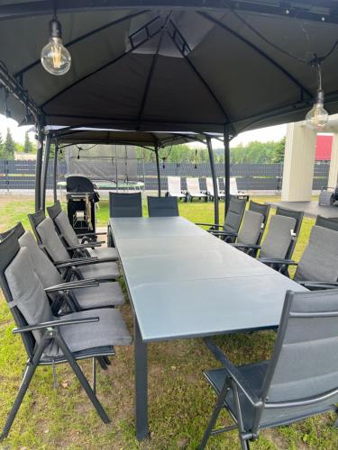 a large table and chairs under a tent at Mazurskie Niebo Apartament 1 in Gołdap