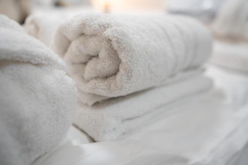 a stuffed teddy bear laying on a bed at Hotel Maslina in Seget