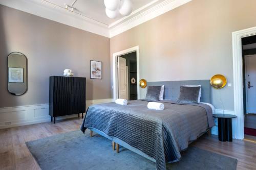 a bedroom with a bed and a mirror at Deluxe Apartment at Perfect Location in Copenhagen