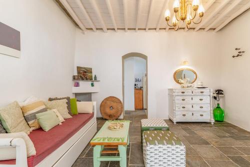 a living room with a couch and a table at Sifnos Waterfront House in Platis Yialos Sifnos