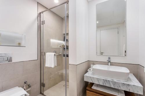 a bathroom with a sink and a shower at One Bedroom Apartment in Madinat Jumeirah Living by The S Holiday Homes in Dubai