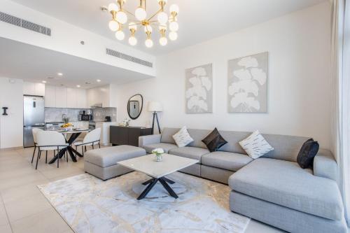 a living room with a couch and a table at One Bedroom Apartment in Madinat Jumeirah Living by The S Holiday Homes in Dubai