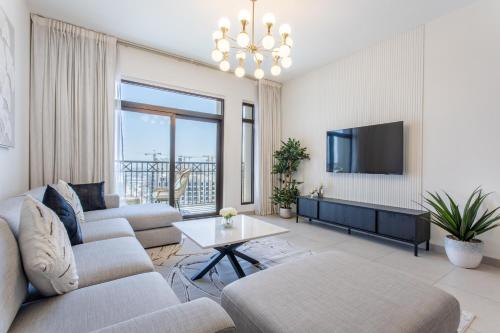 a living room with two couches and a tv at One Bedroom Apartment in Madinat Jumeirah Living by The S Holiday Homes in Dubai