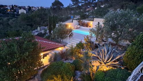 an aerial view of a house with a swimming pool at night at Apartmani Stipe in Drage