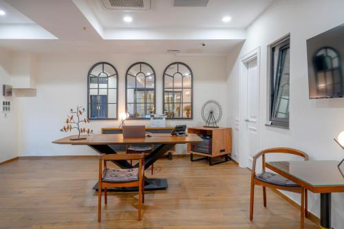 an office with a wooden table and chairs at Iris Hotel in Tbilisi City
