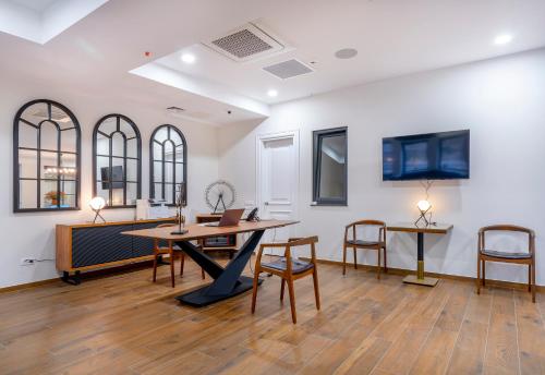 a room with a table and chairs and a desk at Iris Hotel in Tbilisi City