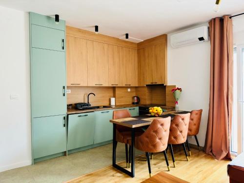 a kitchen with blue cabinets and a table and chairs at Nonna Marija in Kotor