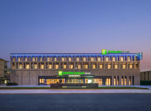 a building with a sign on top of it at Holiday Inn Express Beijing Zhongguancun Tech Park by IHG l Next to The Old Summer Palace & Beijing Sport University l Taxi 10 Minutes to Summer Palace & Peking University & Tsinghua University in Beijing