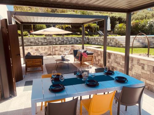 a blue table and chairs on a patio at Relaxing Villa Cefalù - Private Pool & Beach Walk by flAle's in Cefalù