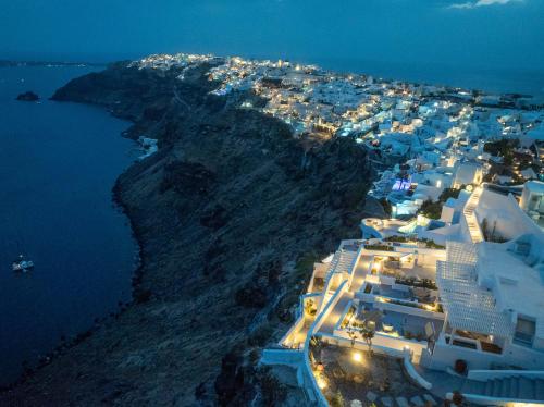 an aerial view of a island at night at IKIES Santorini in Oia