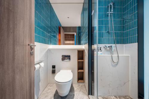 a bathroom with a toilet and a shower at Holiday Inn Express Beijing Zhongguancun Tech Park by IHG l Next to The Old Summer Palace & Beijing Sport University l Taxi 10 Minutes to Summer Palace & Peking University & Tsinghua University in Beijing