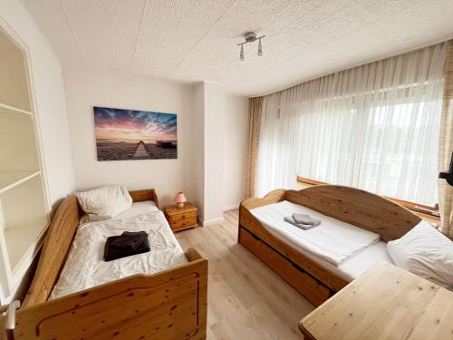 a bedroom with two beds and a window at 5 Room Apartment in Zülpich in Zülpich