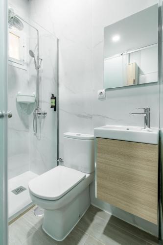 a bathroom with a toilet and a sink and a shower at Sol Apartment III - En el centro de Madrid in Madrid