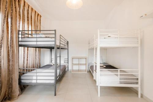 a room with three bunk beds and a window at Delmare Delia maisonette in Yerakiní