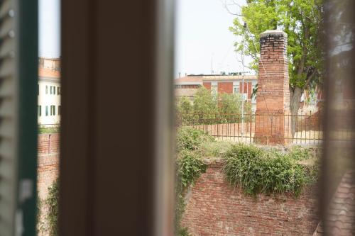 a view of a brick building from a window at B&B Le Mura in Grosseto