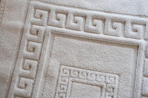 a white stone with a design on it at B&B Le Mura in Grosseto