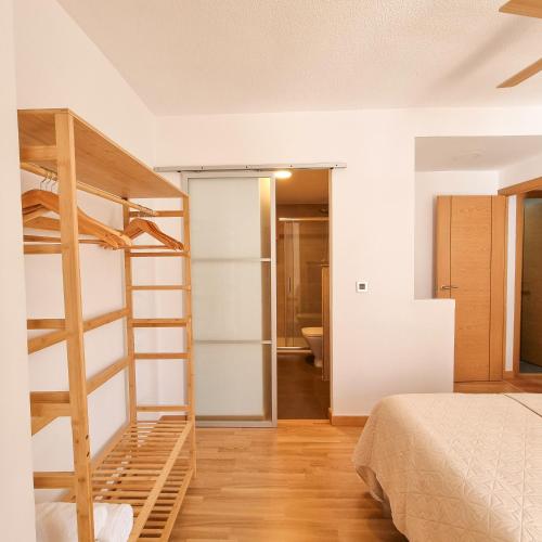 a bedroom with a bunk bed and a bathroom at Portichuelo Playa in Almuñécar