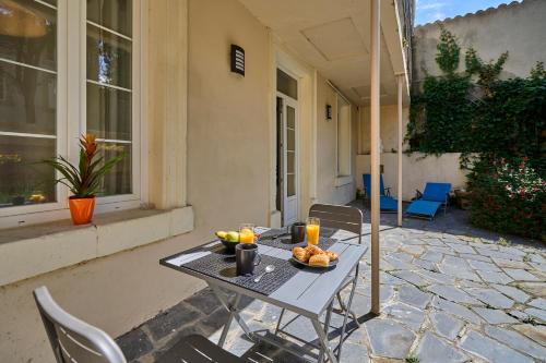 une table avec un bol de fruits sur une terrasse dans l'établissement Le DONJON DIONYSOS - Love Room, à Carcassonne