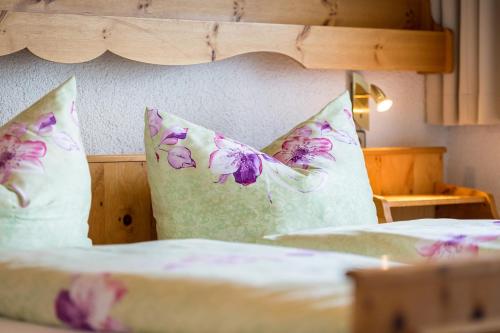 a bedroom with two beds with pillows at Ferienpension Steiner in Weerberg