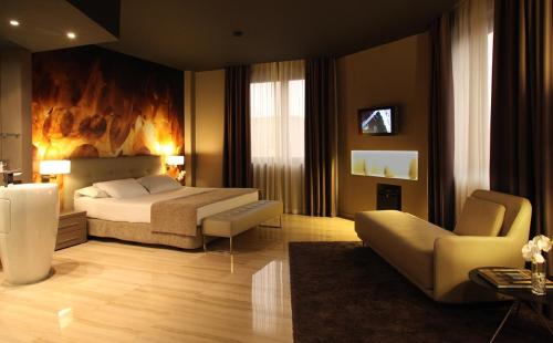 een slaapkamer met een bed en een woonkamer bij Hotel SB Ciutat Tarragona in Tarragona