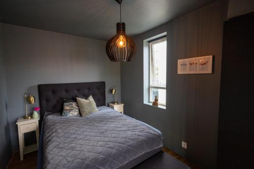 a bedroom with a bed and a window at Modern Apartment - Amazing Terrace and Fjord View, Close to City Center in Bergen