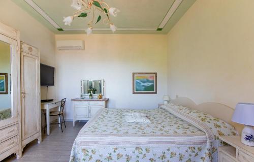 a bedroom with a bed and a table and a desk at Villa Romantica Sea View in Camaiore