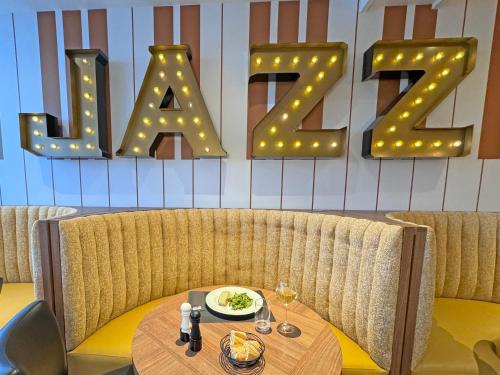 a restaurant with a table and a sign with the word rave at Kyriad - Créteil - Bonneuil-sur-Marne in Bonneuil-sur-Marne