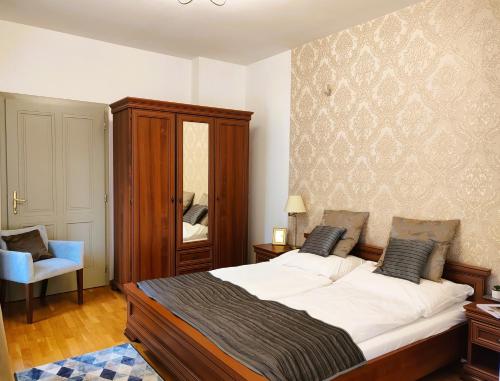 a bedroom with a large bed and a mirror at Városi Vendégház Szentendre in Szentendre