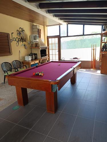 a pool table in the middle of a room at Casa do Castro in Bragança