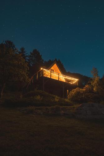 a house with lights on it at night at House Of Harry - horská chata in Liberec