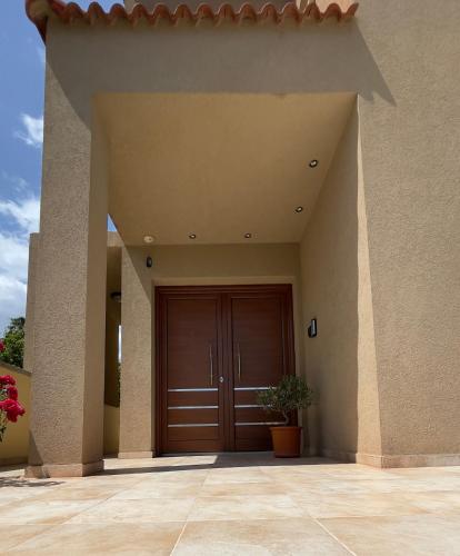a large entrance to a house with a wooden door at Kakopetria's Holiday House in Kakopetria