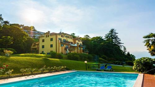 a swimming pool in front of a house at Sole e Lago in Stresa
