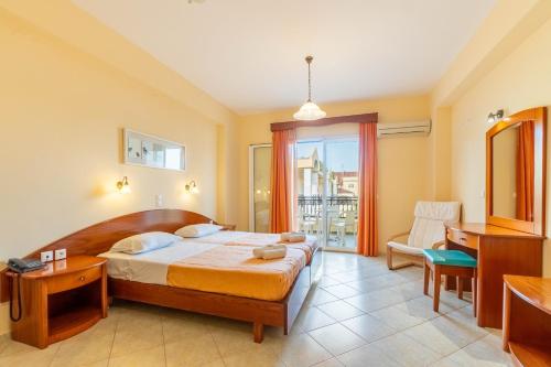 a hotel room with a bed and a window at Kosmos Hotel St6 in Agios Stefanos in Agios Stefanos