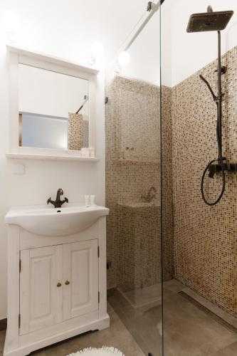 a bathroom with a sink and a shower at Apartamenty w Dworku Cheval in Kraków