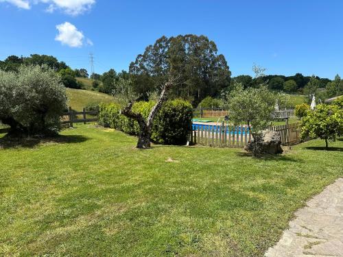 a yard with trees and a fence and a pool at Caserio Kamirune in Laukiz