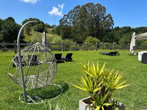 a garden with a metal object in the grass at Caserio Kamirune in Laukiz