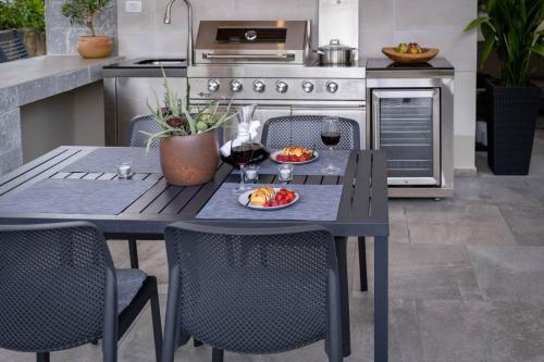 a table with two glasses of wine and a plate of food at Villa Kosta in Krk